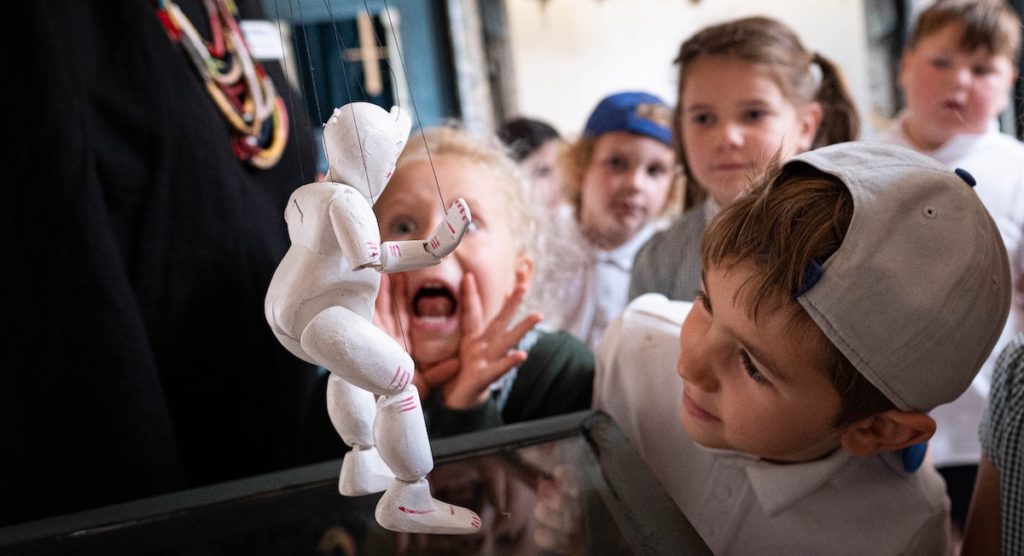 Image of children looking at a puppet