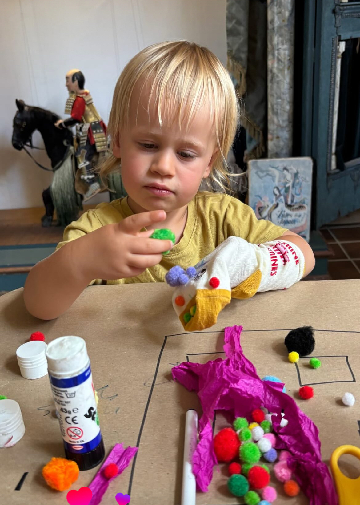 Young child making a sock puppet